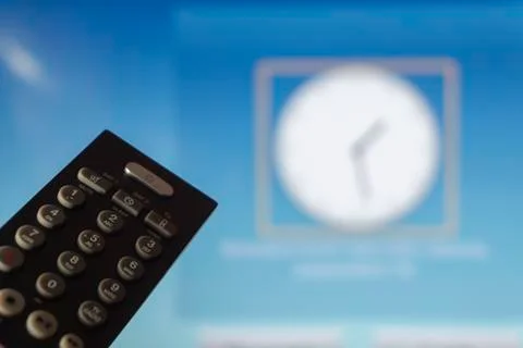 Close-up of remote control and watching smart tv Stock Photos