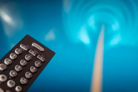 Close-up of remote control and watching smart tv Foto stock