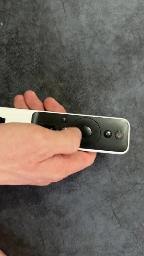 Close up of remote control in hand on sofa, home technology concept showing Stock Footage 336979004