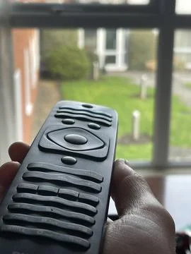 Close up of a remote control in human hand Stock Photos