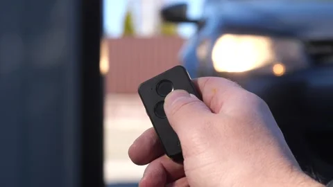 Close-up remote control opens the entrance automatic gate using radio control Video stock 267726555