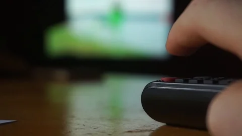 Close up of remote control with silhouettes in the background Stock Footage 117431751