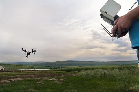 Close up of remote control with tablet for drone in farmer's hands in field.  Stock Photos