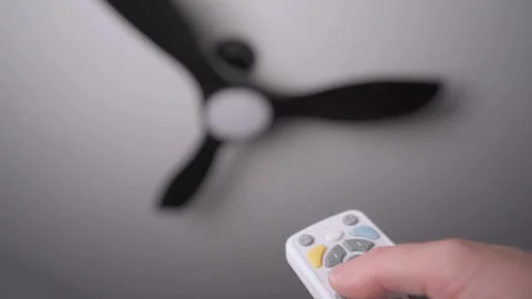 Close up of remote turning ceiling fan on 스톡 동영상 341033339