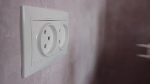 Close-up of removing a child safety plug from an electrical outlet. Child safety Stock Footage 253470736