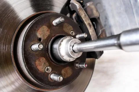 Close-up of removing a hub nut of front drive shaft or disc brake Stock Photos