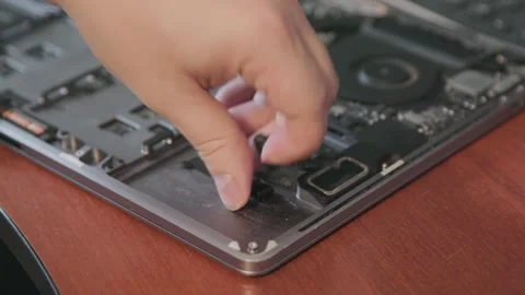 Close-up of removing old double-sided tape and glue residue from a laptop Stock Footage 335560516