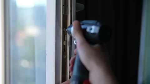 Close-up of repair technician worker using cordless drill to tighten screws on Stock Footage 293250992