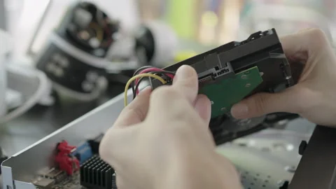Close-up, Repairing or installing hard disk into a security camera recorder. Video stock 332696483