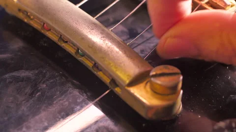 Close-up of replacing the strings on an electric guitar Stock Footage 331720223