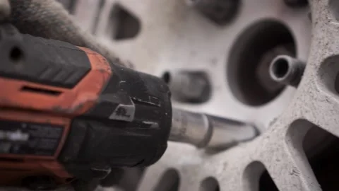 Close-up of replacing a wheel with an electric wrench. Footage. Live footage 스톡 동영상 145430950