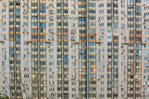Close-up of the residential facade building with windows and balconies. Abstr Stock Photos