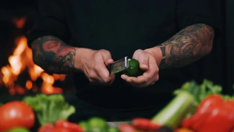 Close up of restaurant chef rubbing a lime peel on a grater in a restaurant Stock Footage 100303073