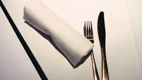 Close-up of a restaurant table setting with napkin, cutlery and glasses, elegant Stock Footage 334998556