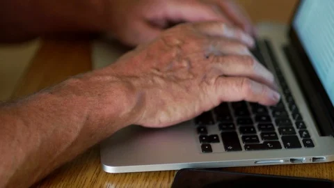 Close up of a retired hand working with a computer keyboard. Internet banking Video stock 91977020
