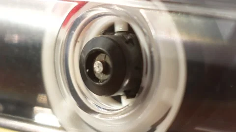 Close-up of retro 80s audio cassette plays back. Cassette tape recorder and rota Stock Footage 165481547