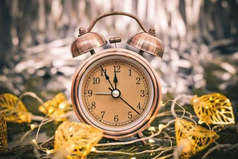 Close up of retro alarm clock on blurred Christmas background with bokeh Stock Photos