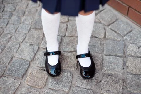 Close-up retro style image of school girl's feet in uniform Stock Photos