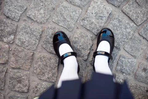 Close-up retro style image of school girl's feet in uniform Stock Photos
