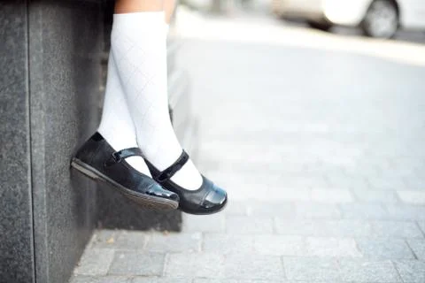 Close-up retro style image of school girl's feet in uniform Stock Photos