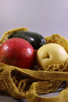 Close-up of a reusable net bag filled with fresh fruit and vegetables Stock Photos