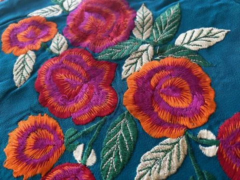 Close-up reveals exquisite silk thread embroidered roses Stock Photos