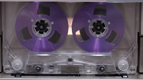 Close-up of rewinding cassette tape wheels in cassette deck recorder Stock Footage 120538172