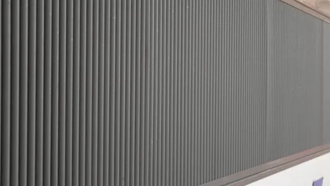 Close-up of the ribbed metal side panel of a train carriage, Cannes, France 库存影片 344825630