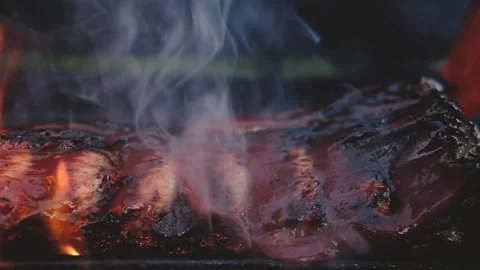 Close-up of ribs fried on grill in flame poured with sweet BBQ sauce 스톡 동영상 161900035