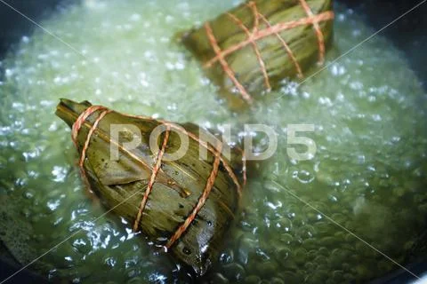 Close up rice dumpling (zongzi) in boiling water. Traditional Chinese food Stock Photos