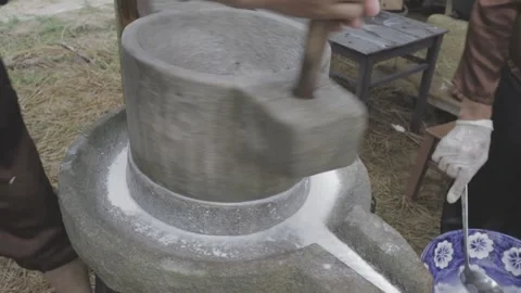 Close-up of the Rice Flour Rotator tool on the Stone Mortar Stock Footage 260364403