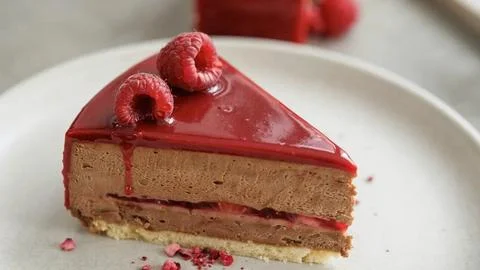 Close-up of a rich chocolate cake with raspberry filling, topped with glossy Stock Photos