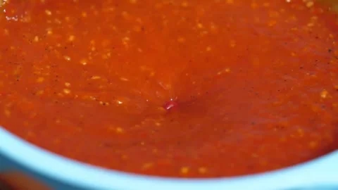 Close up of rich, thick red barbecue sauce or spicy steak marinade in a blue bow Stock Footage 338212279