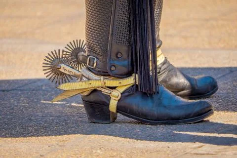 Close up of riding spurs with sharp spikes rowel on authentic western cowboy Stock Photos