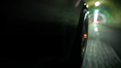 Close-Up of Right Front Wheel of Vehicle in Tunnel Stock Footage 92393150