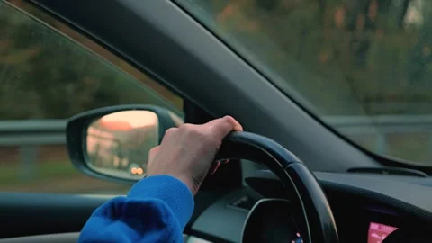 Close-up of the right hand holding the steering wheel of the car Stock Footage 301008490