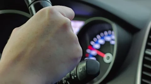 Close-up of right hand holding the steering wheel of a car Stock Footage 303239707
