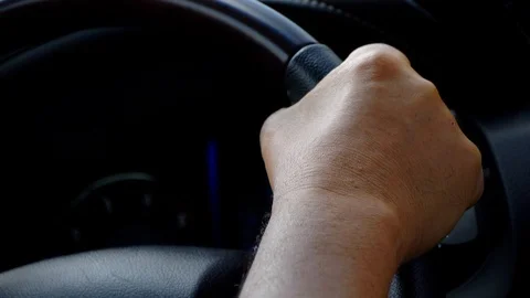 Close up of right man hand holding steering wheel and driving luxury car. Stock Footage 125057980