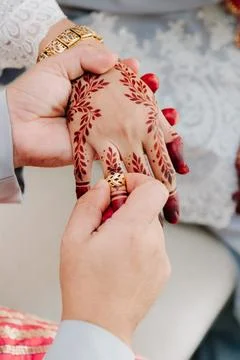 Close-up of Ring Exchange with Detailed Leaf Henna Stock Photos