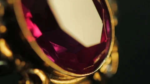 A close-up of a ring with a large red sparkling and shiny ruby Stock Footage 74308927