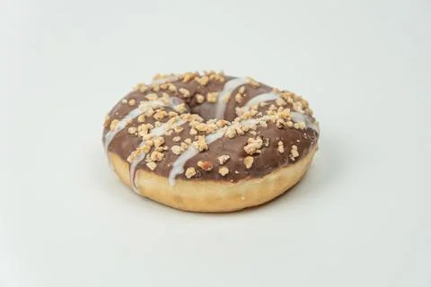 Close-up of ring-shaped doughnut on white surface, freshly baked with glossy  Stock Photos