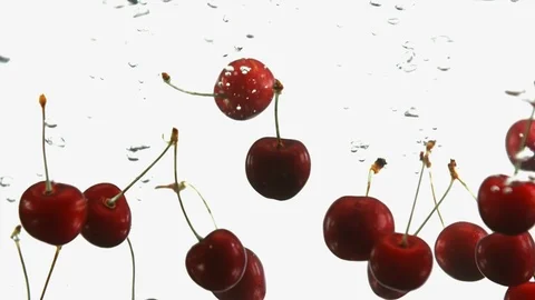 Close up of ripe cherry cherries fall into water white background. Red berries Stock Footage 91021027