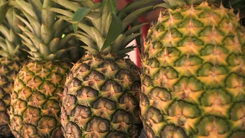 Close up of ripe pineapples on the counter of a fruit shop. Fresh fruits, juices Stock Footage 235219457