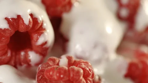 Close-up of ripe raspberries with cream. Loopable. Stock Footage 39983742
