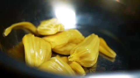 Close up of ripe yellow jackfruit pieces in a shiny metal bowl, ready for e.. Vidéo 339022540