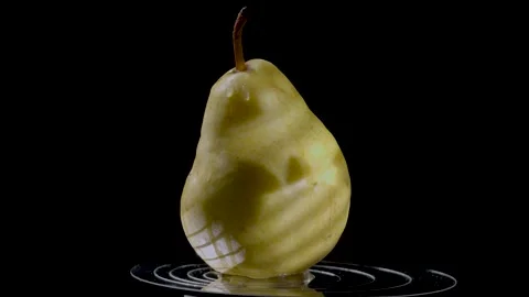 Close-up of a ripe yellow pear against a dark background Stock Footage 345087681
