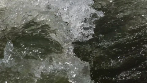Close up of ripples and splashes of clear river water Stock Footage 292842361