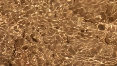 Close up of ripples in clear, shallow river water Stock Footage 321325821