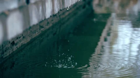 Close-up of ripples in dripping water, raindrops on the water surface Stock Footage 257057516