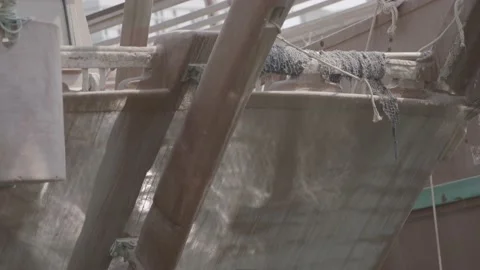 Close-up of ripples of the waves reflecting the sun on the hulls of fishing Stock Footage 135452790